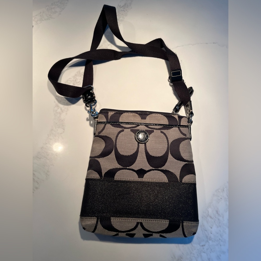 Tan & black canvas coach crossbody bag.  Two outside pockets.